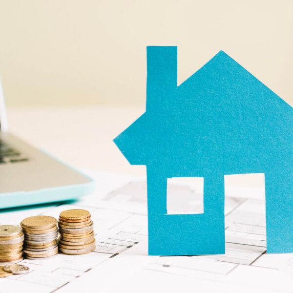 A cardboard house and some coins