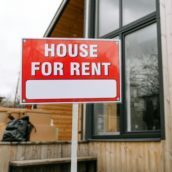 A signpost showing house for rent